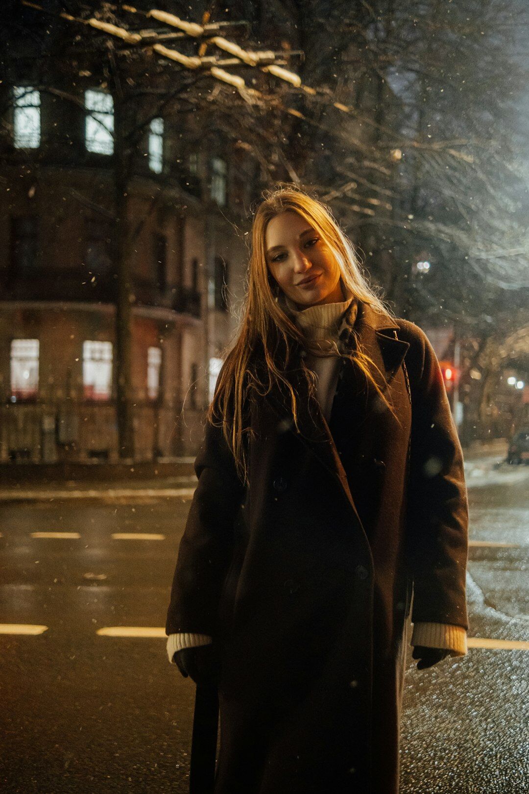 Model wearing a tailored camel coat on a city street