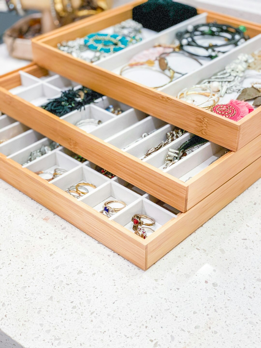 Close-up of gold jewelry and silk fabric on a dressing table