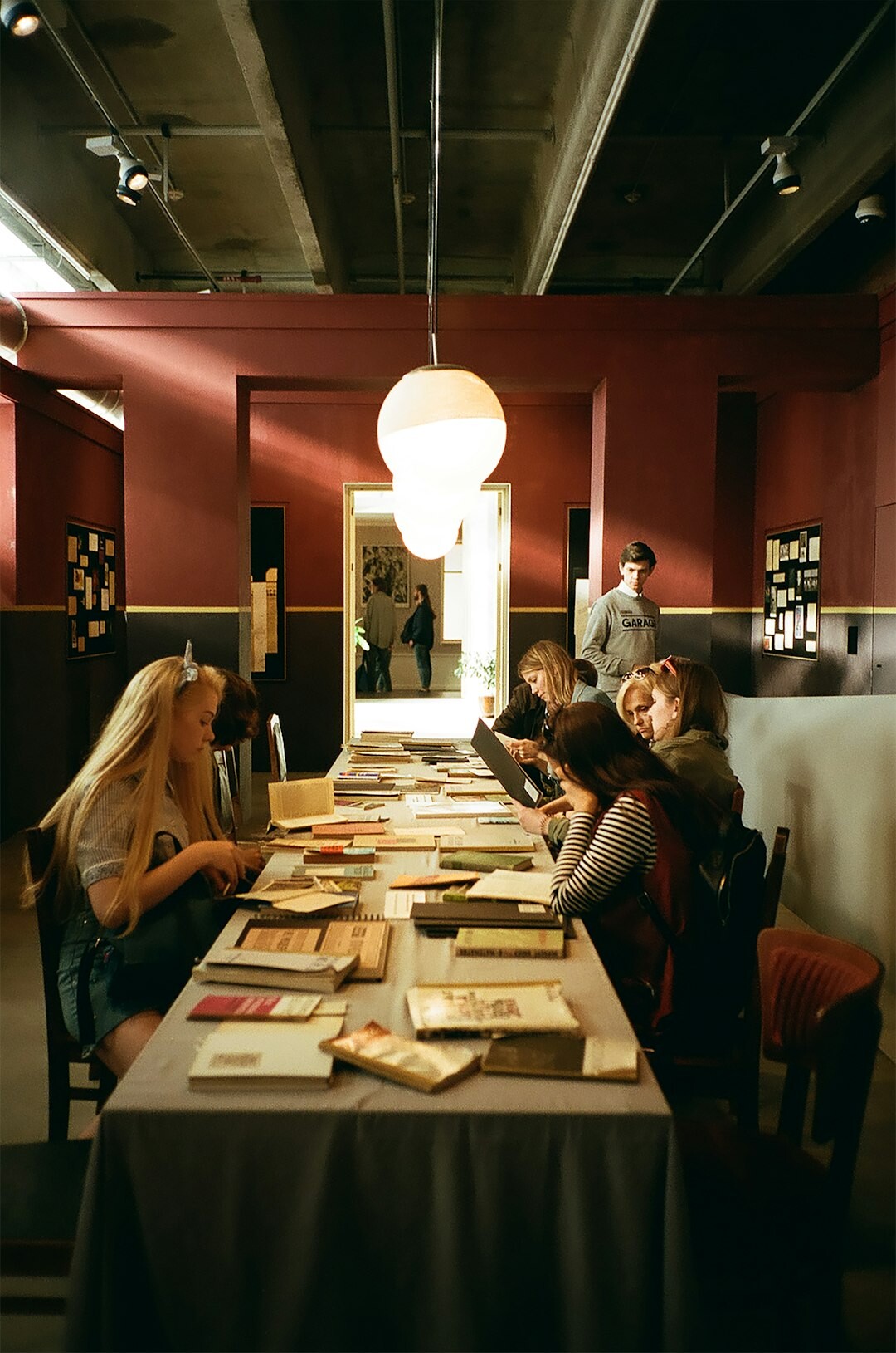 Editorial team reviewing magazine layouts around a table