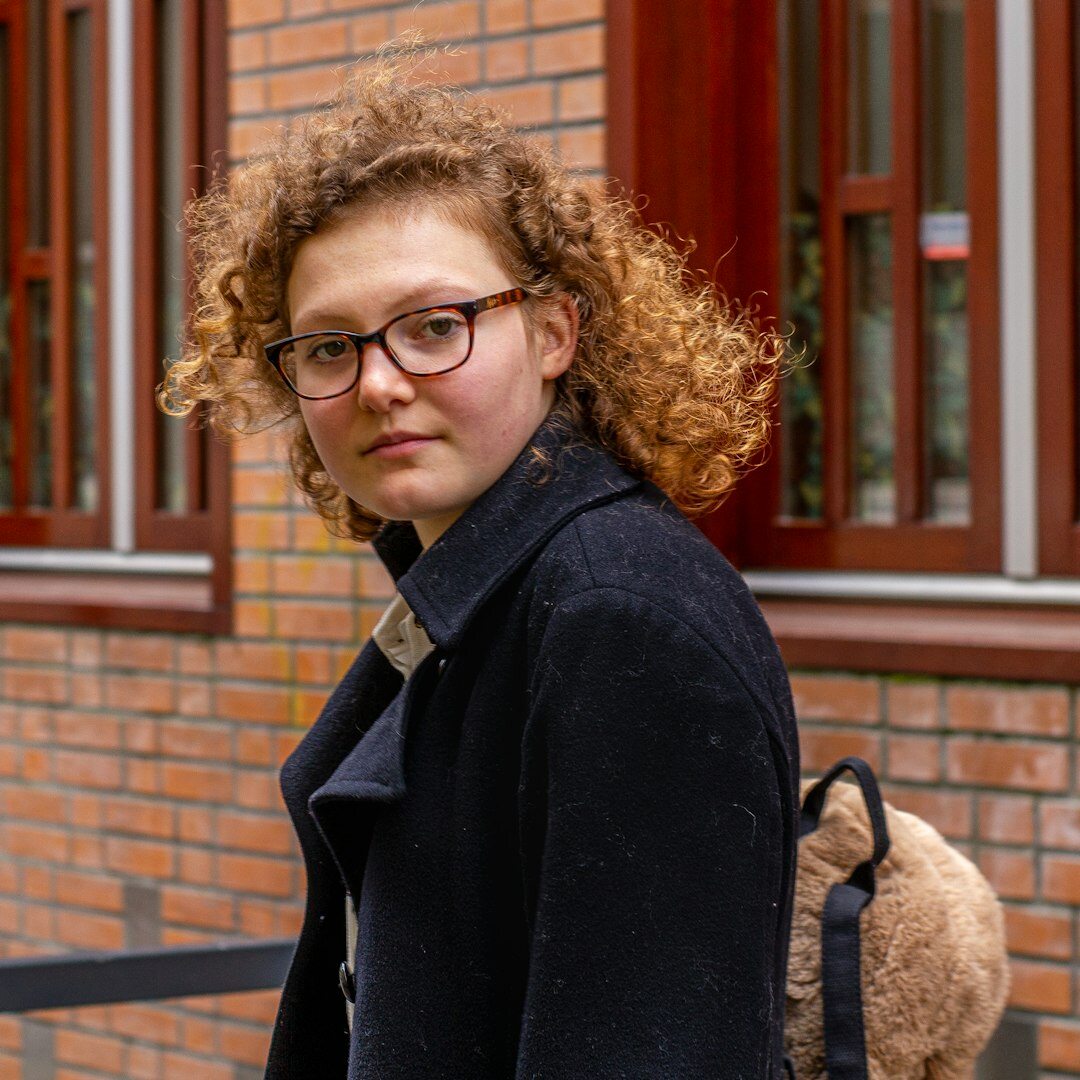 Portrait of the culture editor, a young woman with curly hair